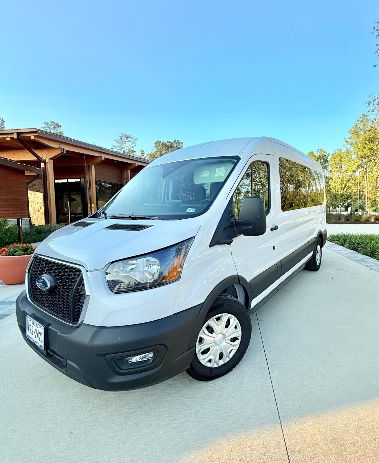 White Ford Transit passenger van parked on a driveway