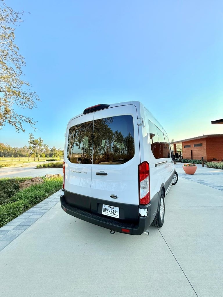 White Ford Transit van parked on driveway in sunny suburban setting